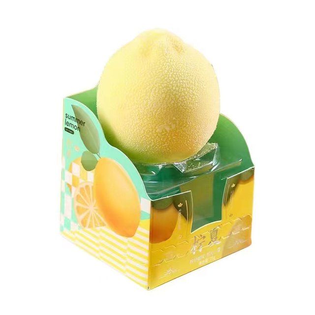 A funky looking lemon sits atop a paper and plastic box. Most of the writing is obscured, except for the words 'summer lemon'